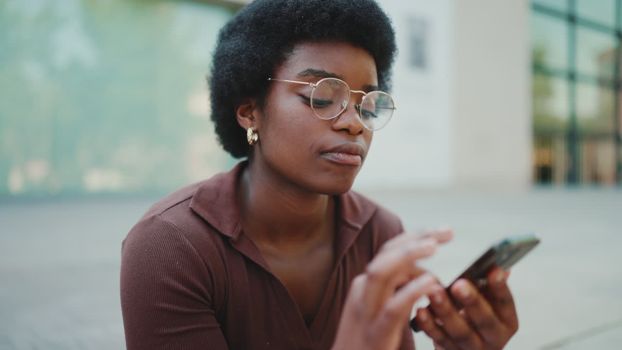 Young woman sending audio via smartphone