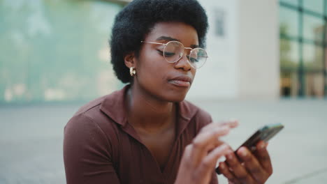 Young-woman-sending-audio-via-smartphone