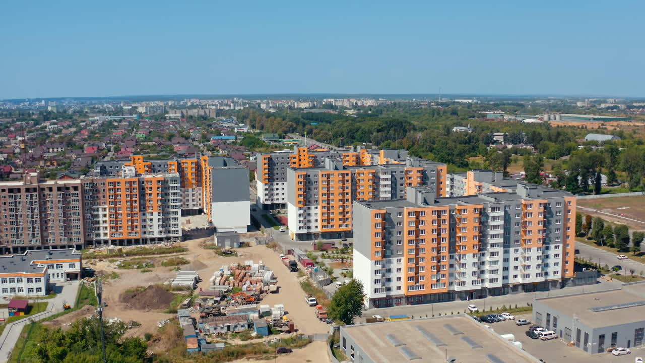Construction of new residential buildings. Modern complex of bright block of flats built in the outskirts of the city. Apartment houses. Aerial view.