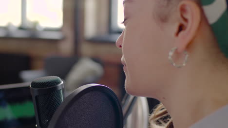 Close-Up-View-Of-Woman-With-Dreadlocks-Talking-Into-A-Microphone-Recording-A-Podcast