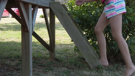 child walks up steps on a playground structure