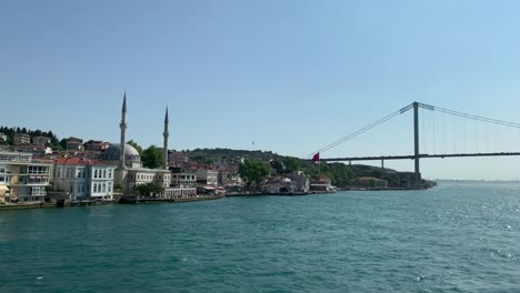 footage of mansions, buildings at upscale neighborhood called "cengelkoy" and bridge in istanbul. it is a beautiful bosphorus scene in a sunny summer day.