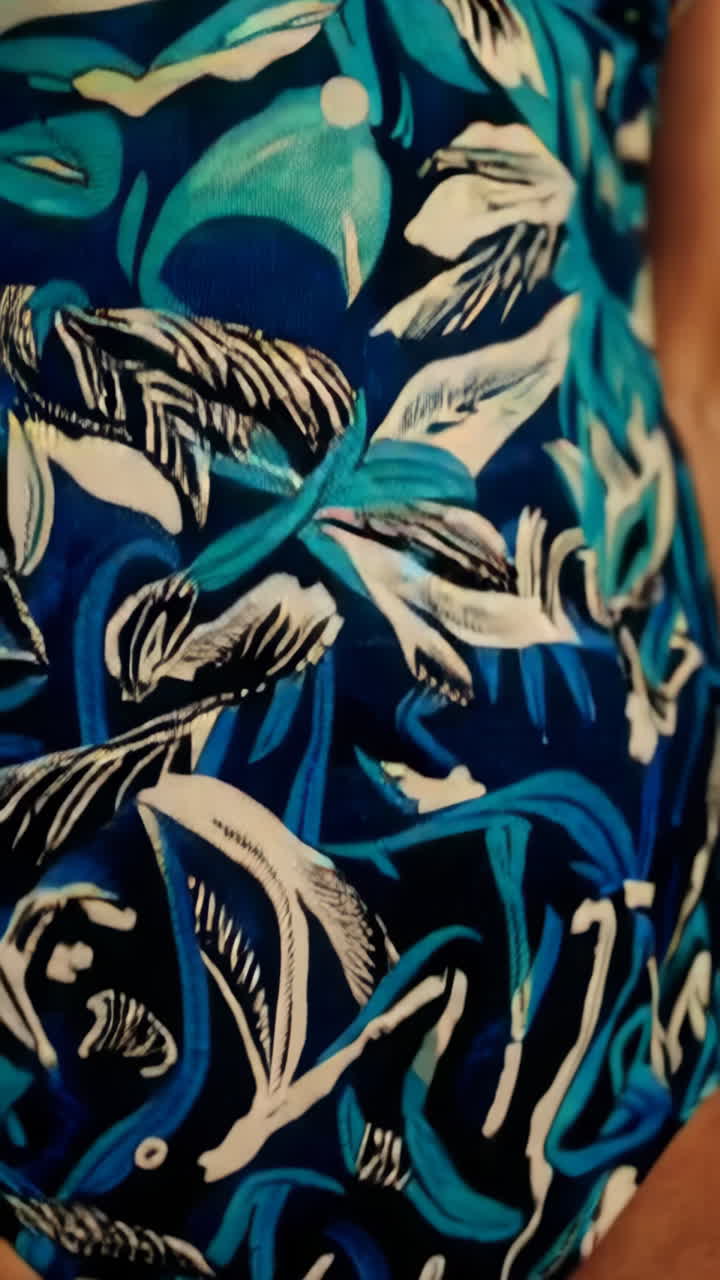 Woman in a Tropical Printed Swimsuit on a Beach