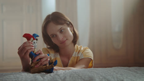a girl playing with dolls in her room