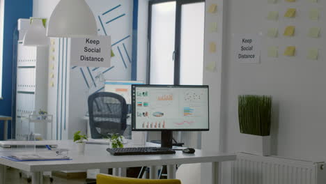 keep social distance sign poster on plastic separator in empty modern office