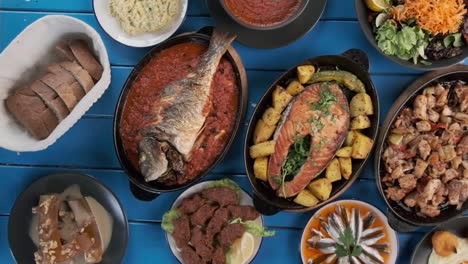 a table full of seafood, two women about to eat, the movie was taken from a 90 degree angle
