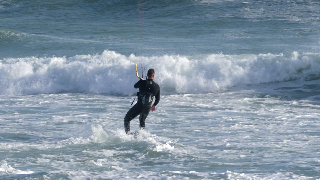 Kitesurfer Riding Waves in the Ocean