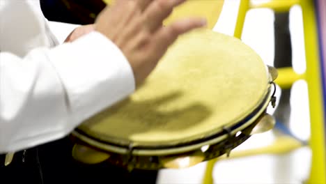 tambourine player at concert, flat plane, video, closeup, side angle