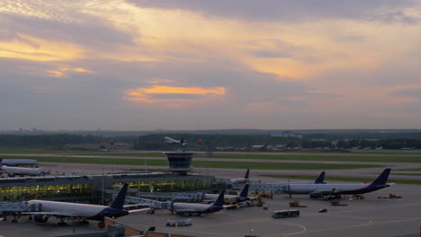 airport view with airplanes boarding and taking off