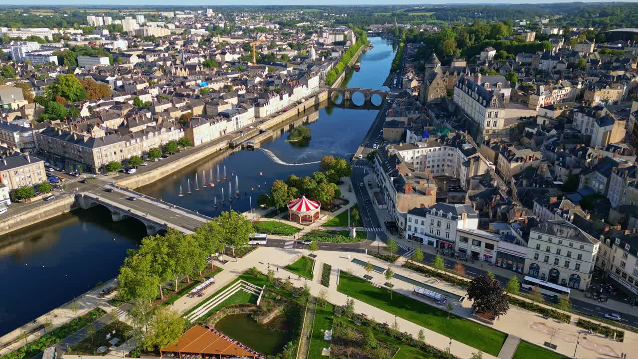 Laval cityscape, Place du 11 Novembre, Château-Neuf, and Mayenne river with bridges, France. Aerial drone forward
