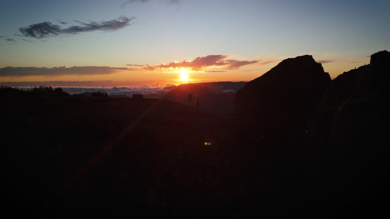 Captivating drone panorama of Pico do Arieiro in Madeira, breathtaking hiking trail at mountain ridges and peaks softly glowing at sunrise