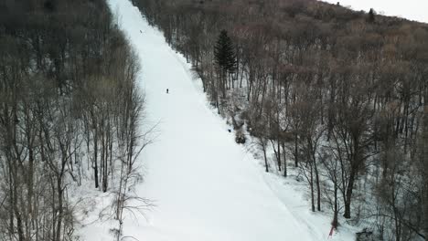 The-aerial-footage-features-a-snowboarder-carving-down-Yabuli-resort's-slopes-with-impressive-skill-and-speed