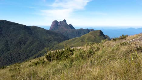 The-majestic-Pico-Paraná-stands-tall-amidst-lush-green-vegetation,-under-a-serene-blue-sky,-offering-a-breathtaking-panorama-of-pristine-wilderness-and-rugged-terrain