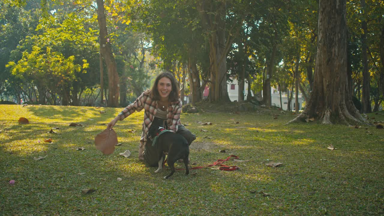 Woman playing with her dog in a park