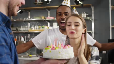 birthday woman blowing out candles on cake