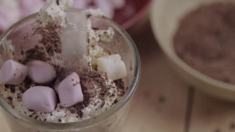 Sprinkling-marshmallows-on-hot-chocolate-drink