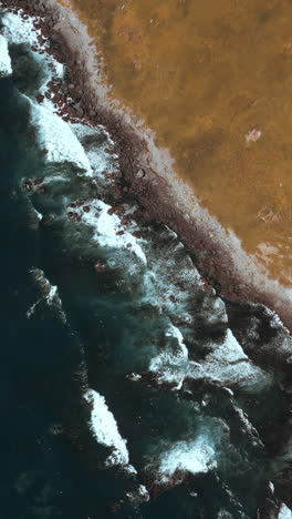 aerial view of rocky coastline and ocean waves