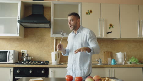man dancing and singing in the kitchen