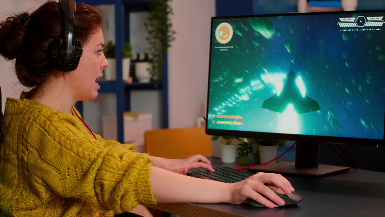 Focused professional woman player wearing headset playing shooter