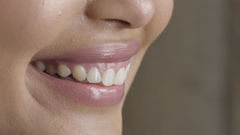 close up woman lips smiling happy wearing glossy lipstick showing healthy teeth dental health concept