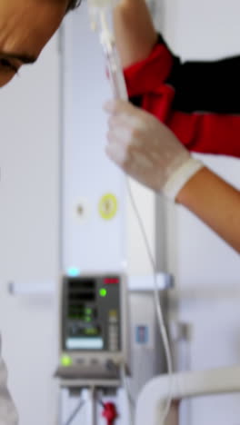 doctor and paramedic examining a patient in emergency room