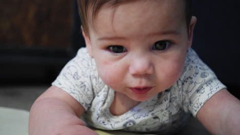 Baby-boy-rests-his-head-on-his-arm-while-learning-how-to-crawl