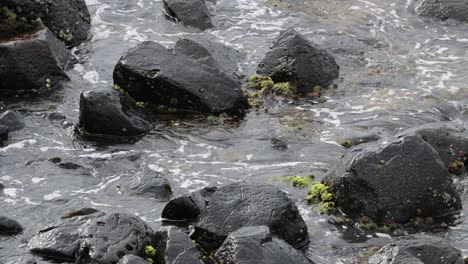 waves interact with rocks along a rugged coastline