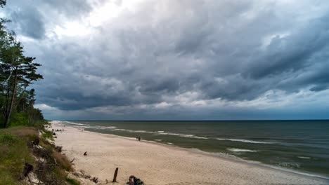 storm clouds over sea and sandy beach time lapse