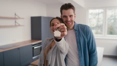 cheerful caucasian couple holding house keys