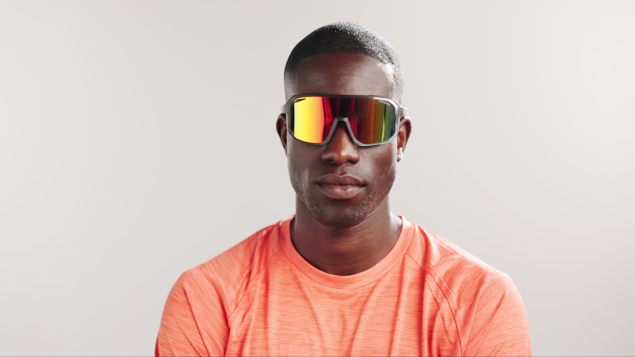 Young Black Man Wearing Reflective Sports Sunglasses in Studio