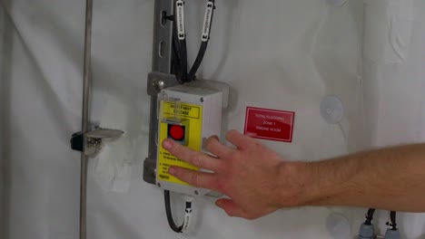 captain hand showing release button, water mist fire fighting system on ship