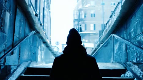 silhouetted male ascending dimly lit urban stairway, moving from shadowy underpass toward promising brightness, symbolizing personal journey and transformative transition