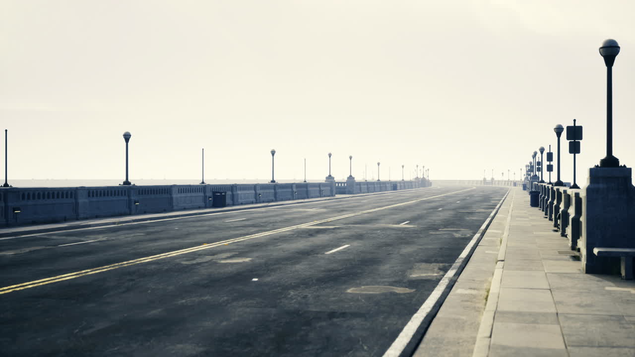 Lonely coastal walkway during early morning with fog in the distance