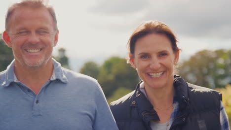 portrait of team of grape pickers at harvest working in vineyard producing wine