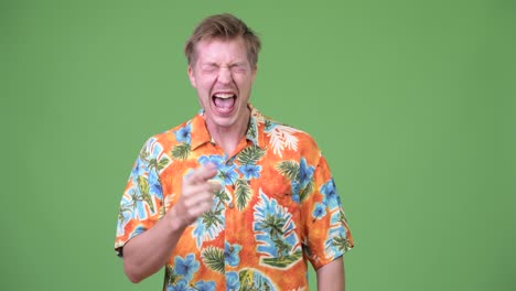 young handsome tourist man laughing