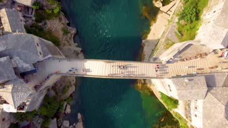 several tourists visiting the iconic arched bridge of stari most at mostar city in bosnia and herzegovina