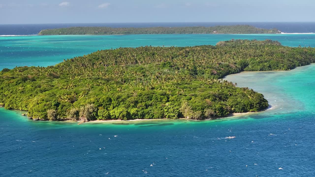 Vava'u, Tonga - A Breathtaking View of an Island Bordered by Vibrant Turquoise Waters and Rich, Dense Tropical Greenery - Aerial Pullback Shot
