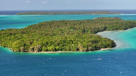 vava'u, tonga - a breathtaking view of an island bordered by vibrant turquoise waters and rich, dense tropical greenery - aerial pullback shot