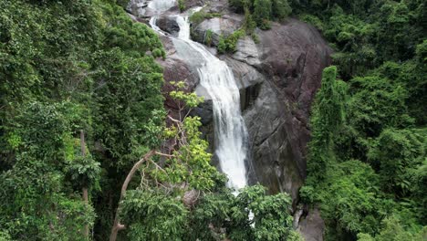 flying through tree foliage of tropical forest with telaga tujuh waterfall in langkawi, kedah, malaysia