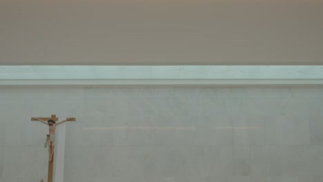 minimalistic church detail with a wooden crucifix against a light, serene background