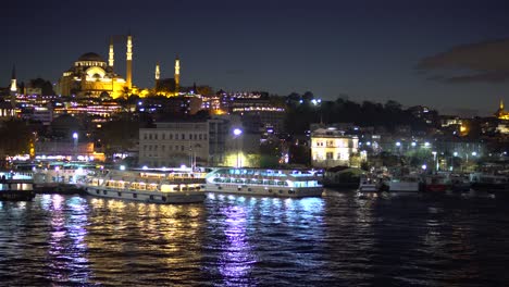 panoramic cityscape view of bosporus and illuminated mosque in istanbul at night