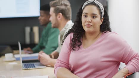 Happy-diverse-business-people-discussing-work-during-meeting-at-office