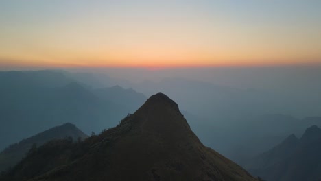 aerial drone shot of kolukkumalai range in the calm of early morning with sunlight breaking through