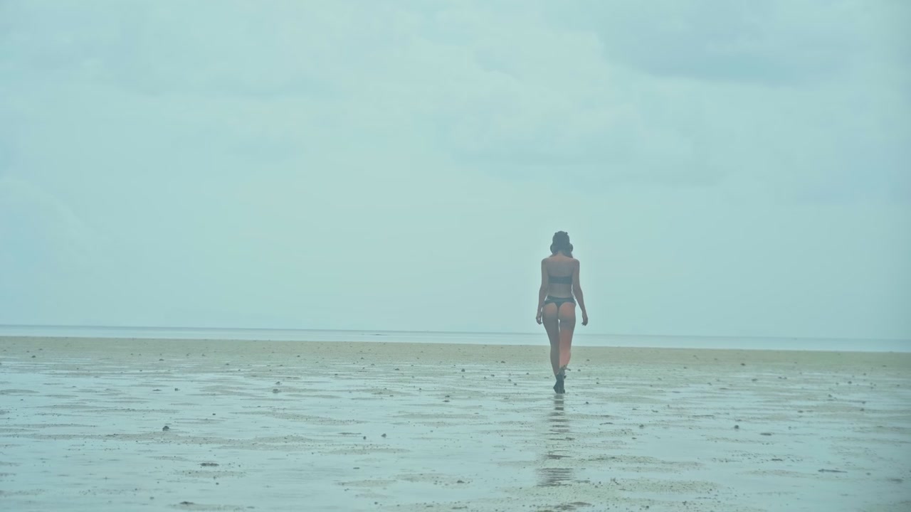 Woman in Bikini Walking Alone on Vast Tidal Flat
