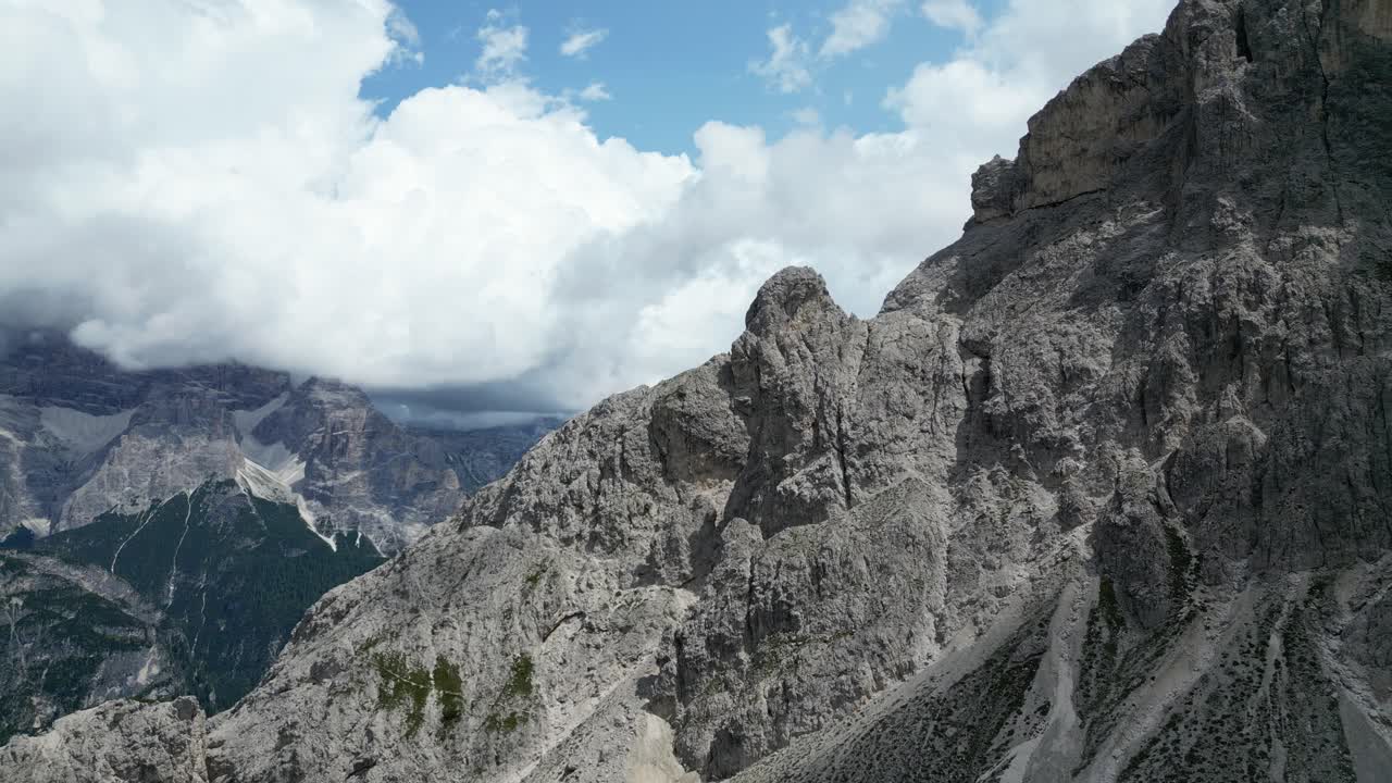 Towers of Mordor, Dolomites, Italy - A Striking Array of Rock Formations Set Against a Cloudy Sky - Drone Flying Forward