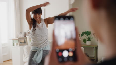 teenage-girl-practing-dance-with-friend-recording-video-using-smartphone-sharing-choreography-moves-on-social-media-best-friends-having-fun-dancing-at-home-4k