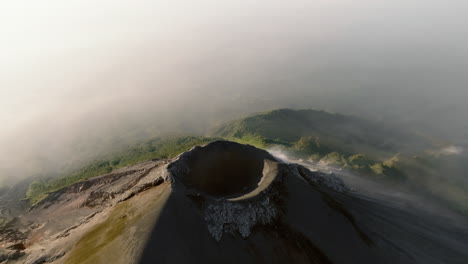 Aerial:-Backwards-reveal-shot-of-active-Fuego-volcano-crater-in-Guatemala-during-sunrise