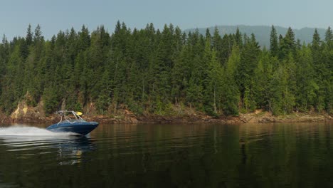 motor boat sales past us on the shushwap lake on a glassy water day