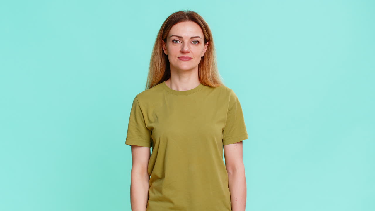 Adult woman showing thumbs up and smiling expressing support agreement approval or positive response