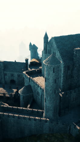 aerial view of a medieval castle in a foggy landscape